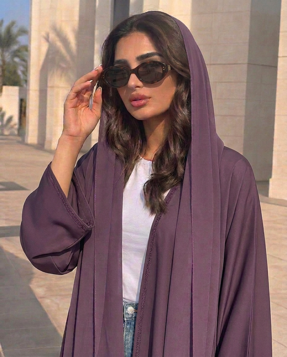 Emirati woman wearing AYZA tortoiseshell rounded sunglasses in sunlight